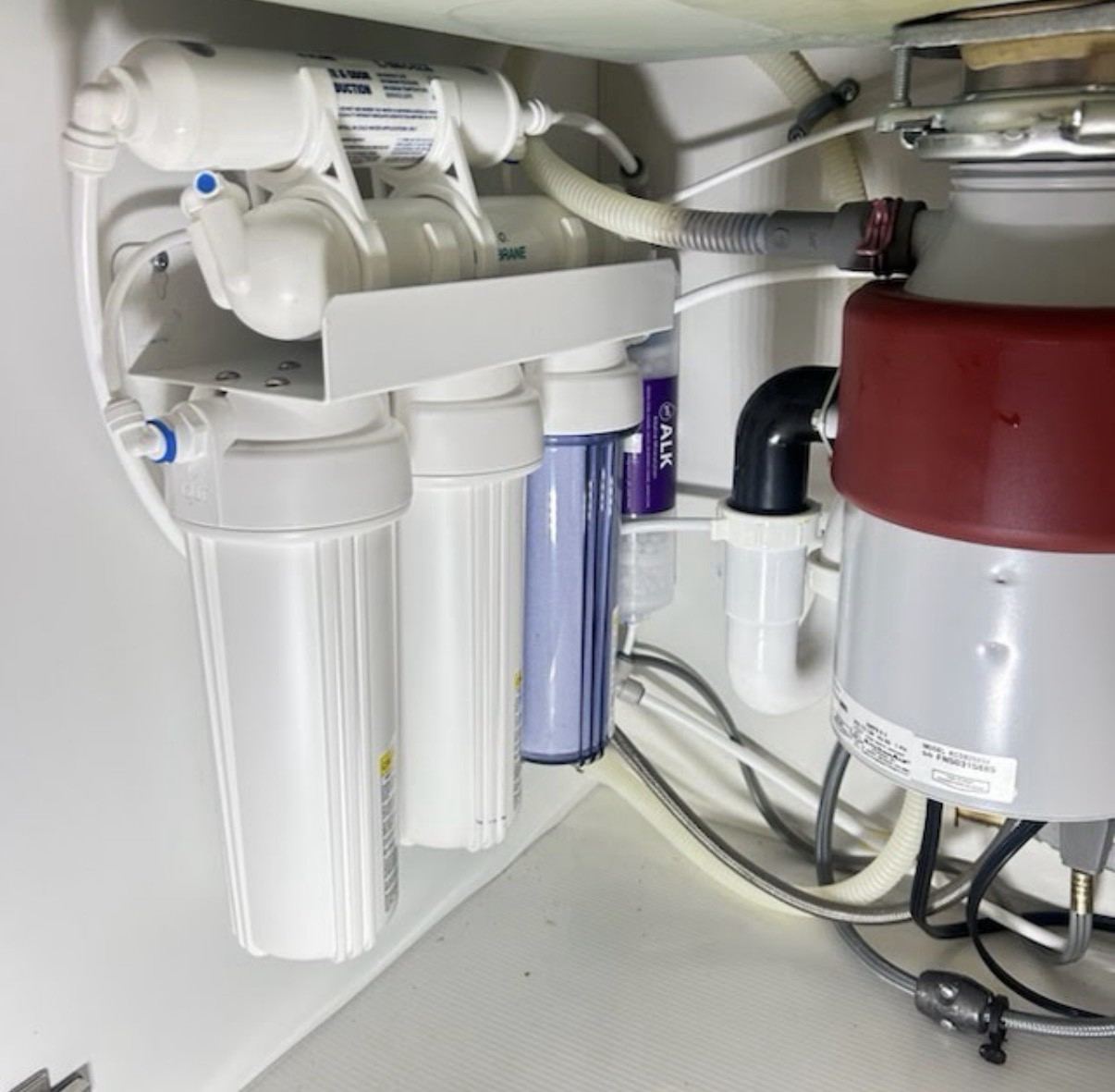 Real 5-stage tank reverse osmosis system installed under a kitchen sink by Airgead